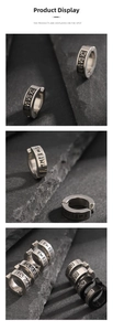 Detail of titanium steel ear clips featuring laser-etched Roman numerals and runes