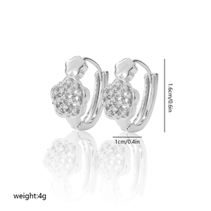 Detailed view of silver-tone floral hoop earrings with sparkling cubic zirconia stones