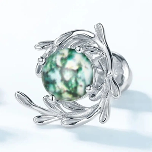 Macro detail of moss green patterned bead set in silver branch style stud earrings