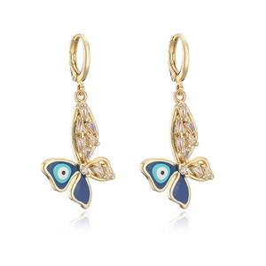 Detail of 18K gold butterfly earrings with blue enamel evil eye and sparkling crystals