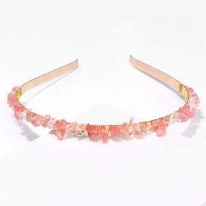 Detail of pink natural raw stone chips hand-wrapped on a golden metal headband for women