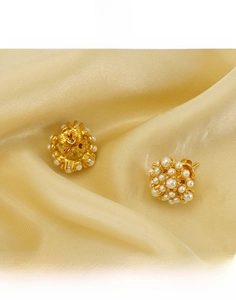 Detail of titanium steel pearl cluster earrings on satin highlighting durable material
