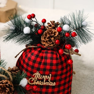 Red and black buffalo plaid Christmas gift bag with pine cones and Merry Christmas tag