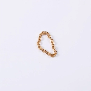 Macro shot of gold plated stainless steel 3mm curb chain ring with detailed metal texture