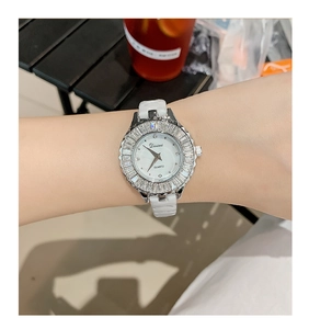 Elegant women's quartz watch with silver diamond bezel and white leather strap on wrist