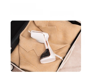Portable handheld steamer inside a suitcase for travel and business trip convenience
