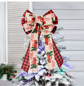 Close-up of red plaid Christmas tree topper bow with rustic burlap truck pattern