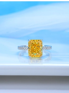 Macro shot of rectangular yellow high carbon diamond ring with silver band details