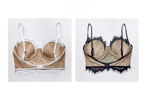 Detailed view of white and black lace bralettes with thin straps and sheer mesh back