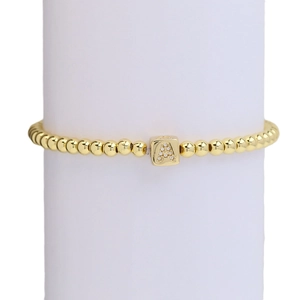Elastic 18k gold beaded bracelet featuring a square pendant with letter A in zircon stones
