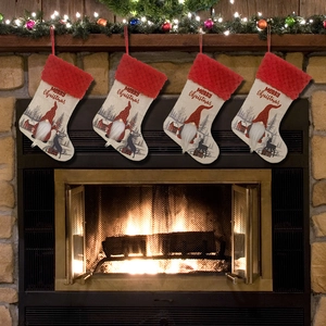 Classic burlap Christmas stockings with Santa and reindeer hanging on a warm fireplace