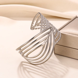 Macro view showing intricate layered geometric patterns and bead textures on wide cuff bangle