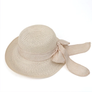 Detailed close-up of breathable mesh straw weaving and a large beige decorative bow