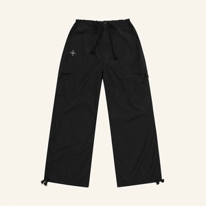 Classic black parachute pants with drawstring waist and crossbody floral logo detail