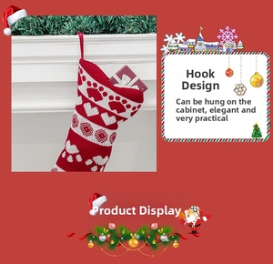 Detail of red and white knitted Christmas bone stocking with paw print and heart pattern