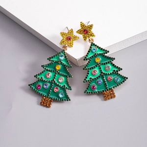 Macro detail of Christmas tree earrings with green enamel, colorful rhinestones and gold stars