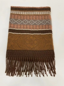 Close-up of ethnic striped scarf with orange geometric patterns and tassel details