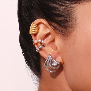 Detailed view of 18K gold and silver geometric ear cuffs with pearls and rhinestones