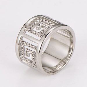 Detailed view of silver wide-band geometric ring featuring Greek key patterns and rhinestones