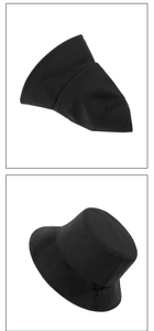 Detail view of a black cotton bucket hat showing side profile and structure on white background