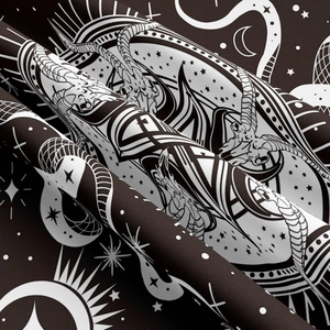 Detail of occult tapestry showing goat skull, moon, and snakes on soft textured fabric