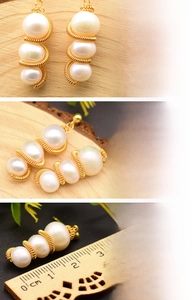 Detailed macro view of triple freshwater pearl earrings with 18K gold wire wrapping