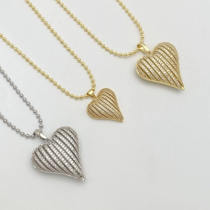 Polished gold and silver heart pendants with micro-inlaid cubic zirconia stones