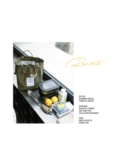 Close-up of green canvas lunch bag with drawstring and leather handles in a lifestyle scene