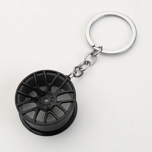 Matte black twin five-spoke metal car wheel hub keychain with a silver metal ring