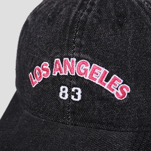 Detailed shot of 3D embroidery showing LOS ANGELES and 83 on washed denim baseball cap