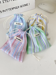 Set of four colorful pleated striped drawstring bags for cosmetics and travel storage