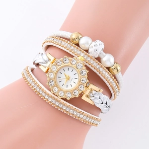 Close-up of a white PU leather wrap watch with rhinestones and pearls on a wrist