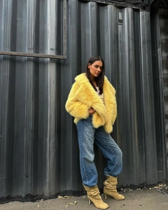 Outdoor street shot of a bright yellow faux fur jacket with soft plush texture details