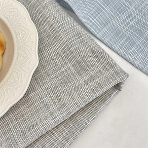 Macro detail of heat-resistant grey plaid linen texture fabric placemat for dining