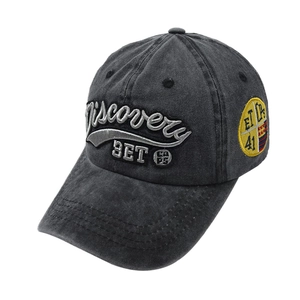 Detail view of washed cotton baseball cap with embroidered logo and side patch