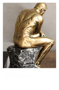 Close-up of golden thinker sculpture with brushed metal texture and retro rock base