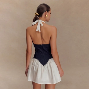 Détail du haut licou en jean bleu foncé avec zip dorsal et mini jupe trapèze blanche
