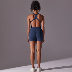 Detail of navy blue seamless yoga jumpsuit featuring a racerback cutout and ribbed texture
