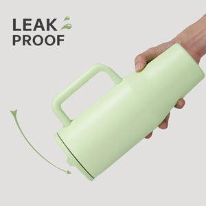 Detail of light green 40oz tumbler being tilted to demonstrate its leak-proof lid feature