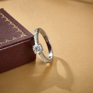 Exquisite 925 sterling silver ring with round brilliant cut moissanite on a red jewelry box