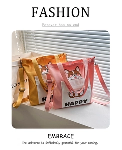 Detail of pink and yellow canvas bags with cartoon corgi print on a white windowsill