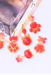 Detail of DIY cat paw silicone mold with finished translucent glitter resin earrings