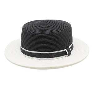 Detail of a black and white boater hat showing fine straw weave texture and flat top design