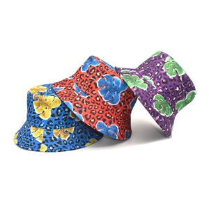 Leopard print and tropical leaf canvas bucket hats in blue, red, and purple colors