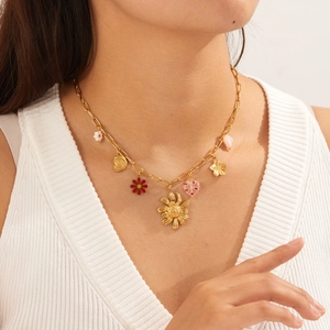 Gold plated sunflower daisy heart pendant necklace on model with summer vibes