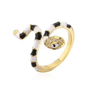 Detail of gold snake ring with black and white enamel and sparkling zircon evil eye