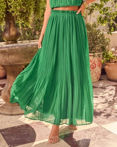 Detail of green pleated maxi skirt showing high-quality fabric texture and flowing design