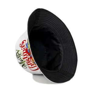 Reversible Christmas bucket hat with Merry Christmas print on white and black fabric