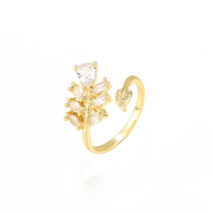 Golden open leaf ring featuring sparkling cubic zirconia stones on a white background