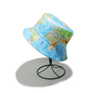 Sky blue world map print bucket hat for outdoor sun protection on a metal stand